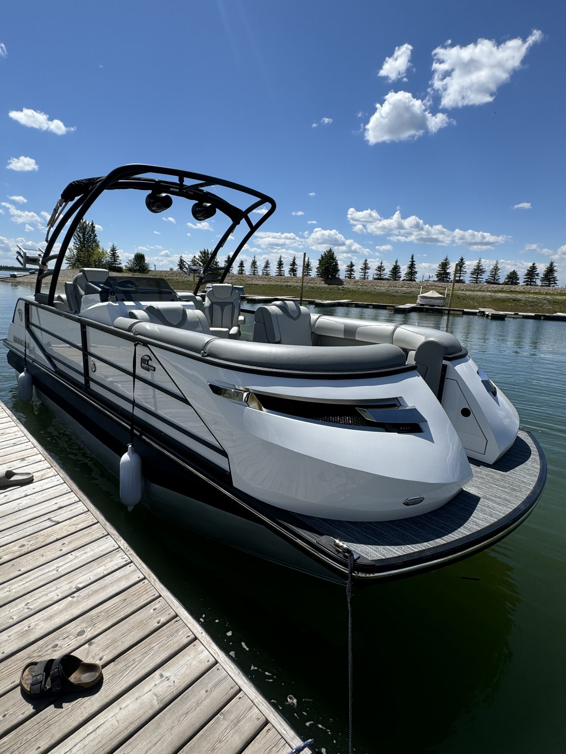 Modern wake surf boat at marina dock in BC